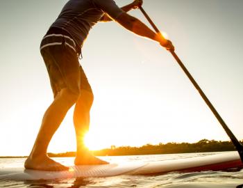 A man stands on a SUP board