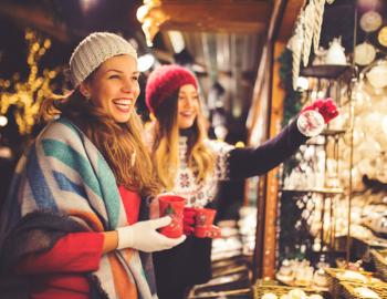 Two women enjoy a day at a Christmas market