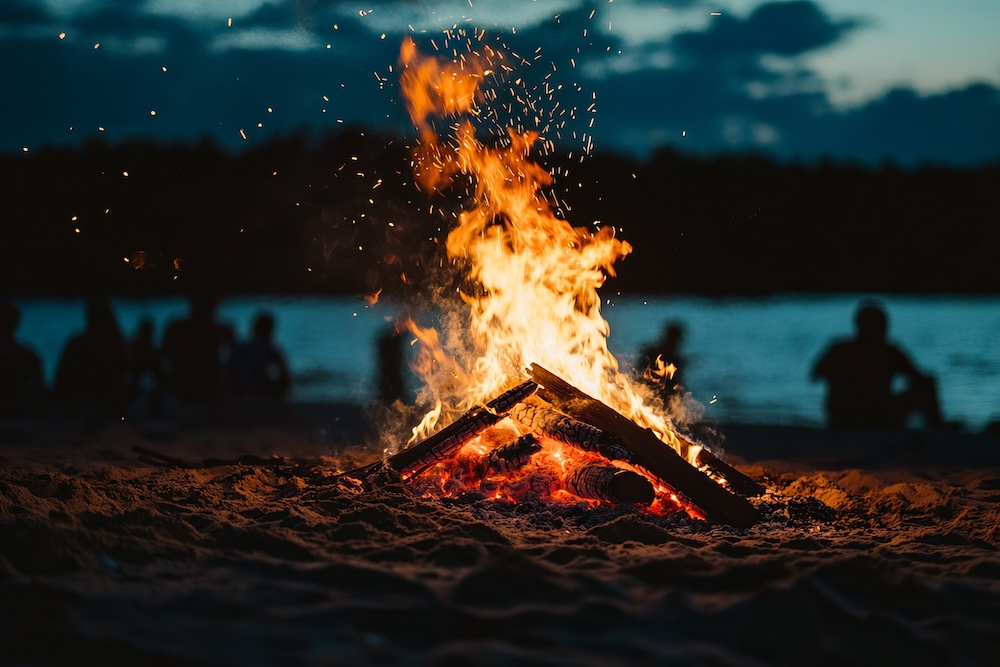 Bonfire on the beach at night with light.