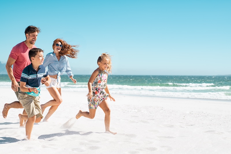 Family running on beach - 30A vacation