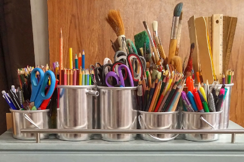Paint brushes sit in a studio
